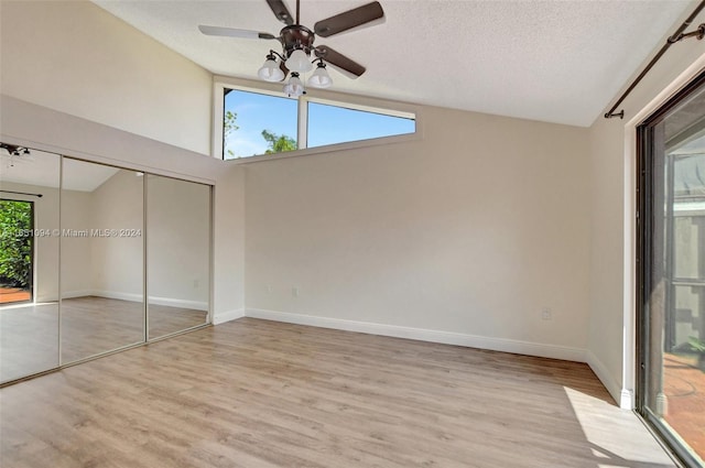 empty room featuring a textured ceiling, hardwood / wood-style flooring, and ceiling fan