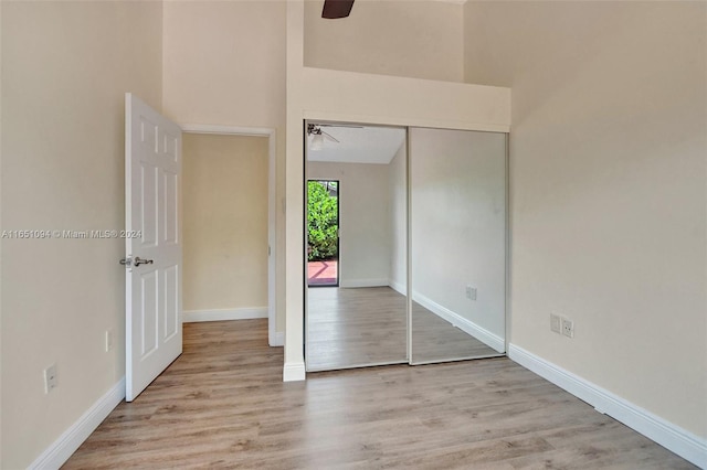 unfurnished bedroom featuring a closet, ceiling fan, and light hardwood / wood-style flooring