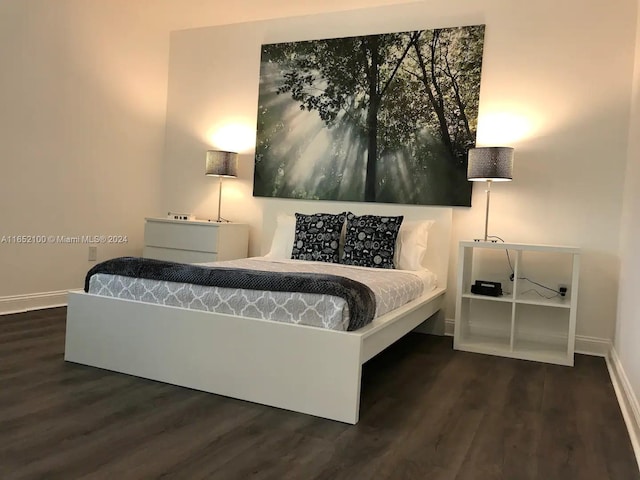 bedroom with dark hardwood / wood-style flooring