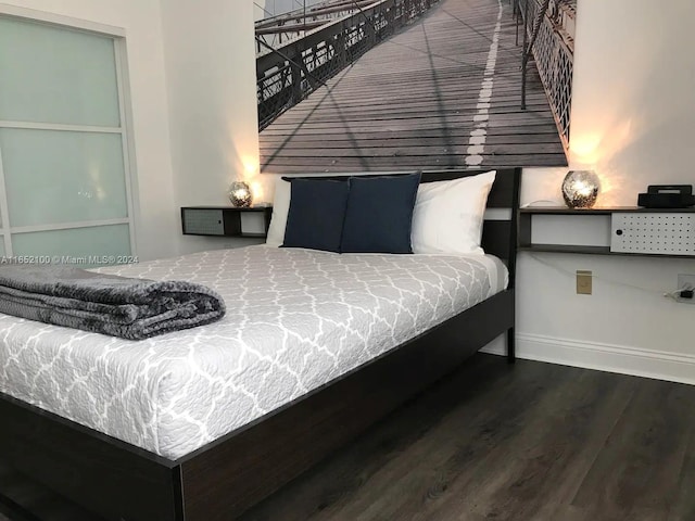 bedroom with hardwood / wood-style floors