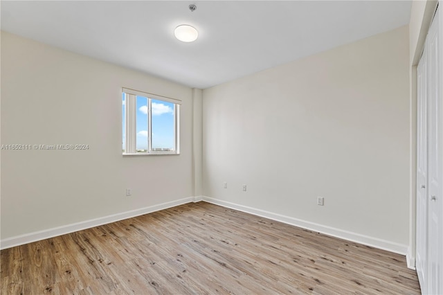 unfurnished room with light hardwood / wood-style flooring