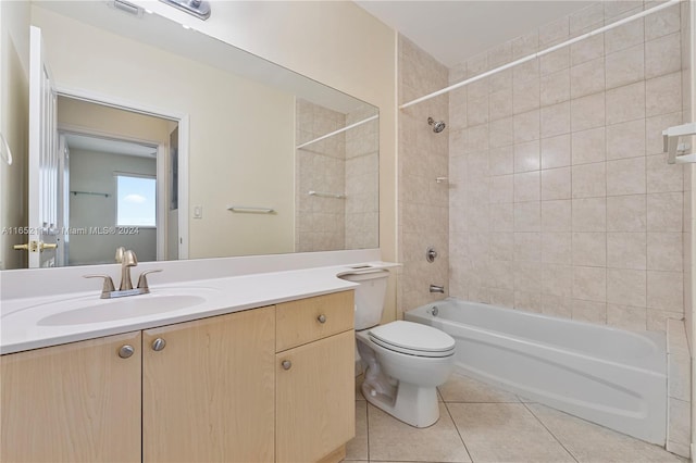 full bathroom featuring tile patterned floors, vanity, toilet, and tiled shower / bath