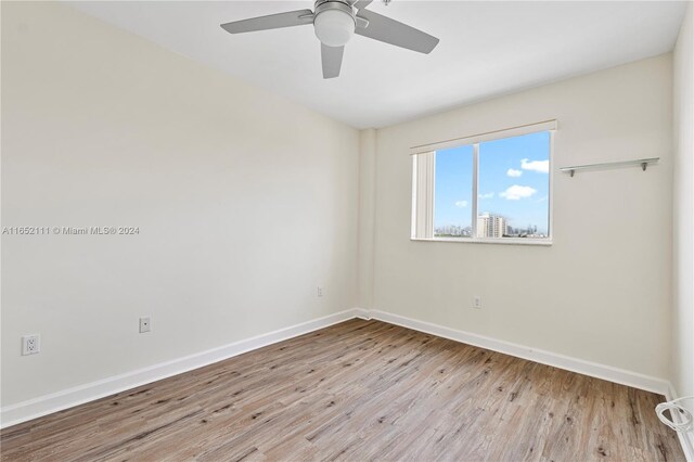 empty room with light hardwood / wood-style floors and ceiling fan