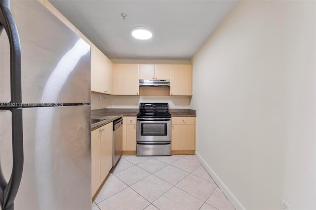 kitchen featuring light brown cabinets, light tile patterned floors, and stainless steel appliances