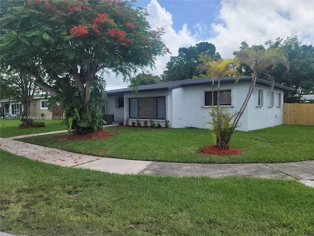 ranch-style house with a front lawn