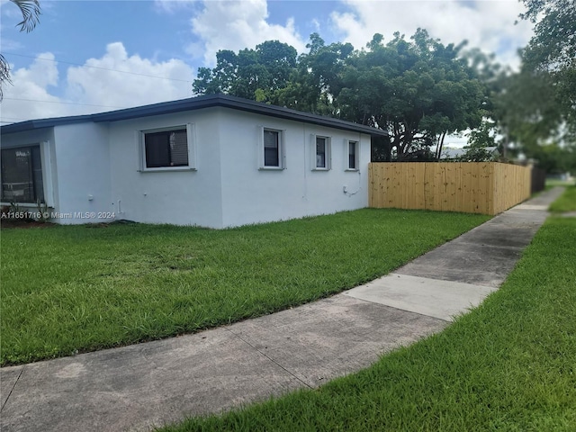 view of home's exterior with a yard