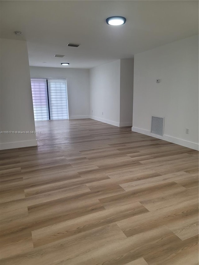 spare room with light wood-type flooring