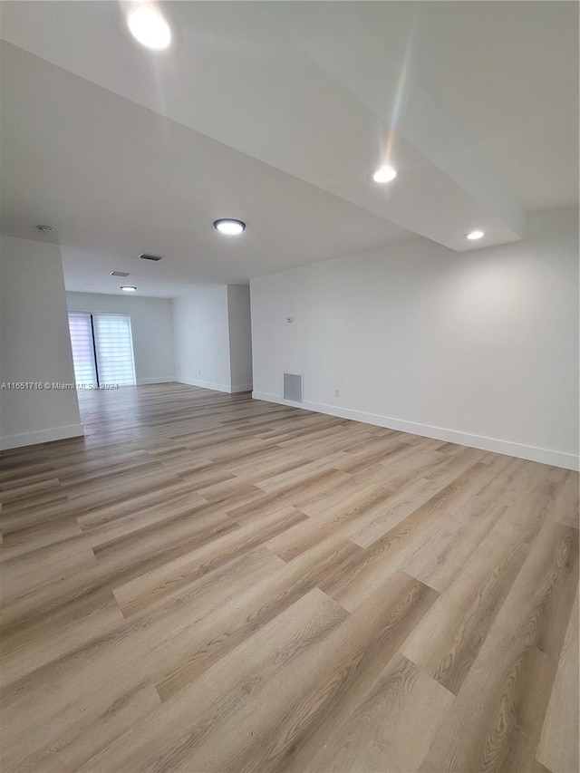 empty room with light hardwood / wood-style flooring