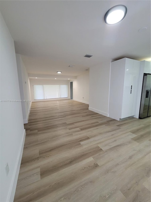 empty room with light hardwood / wood-style floors