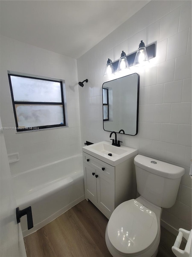 full bathroom with vanity, tile walls, hardwood / wood-style flooring, and toilet