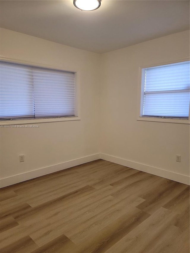 spare room featuring wood-type flooring