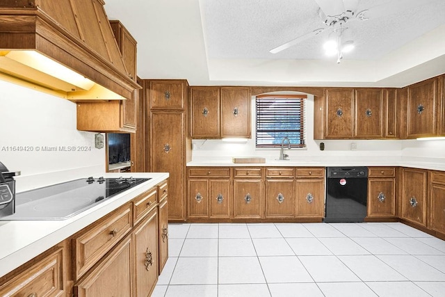 kitchen with a textured ceiling, black appliances, ceiling fan, custom exhaust hood, and light tile patterned flooring