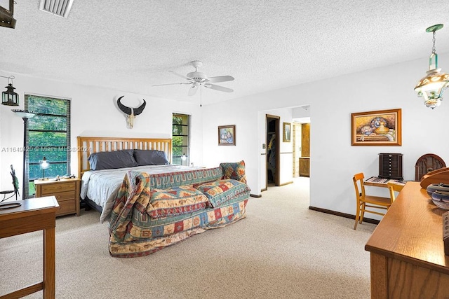 carpeted bedroom featuring a textured ceiling and ceiling fan