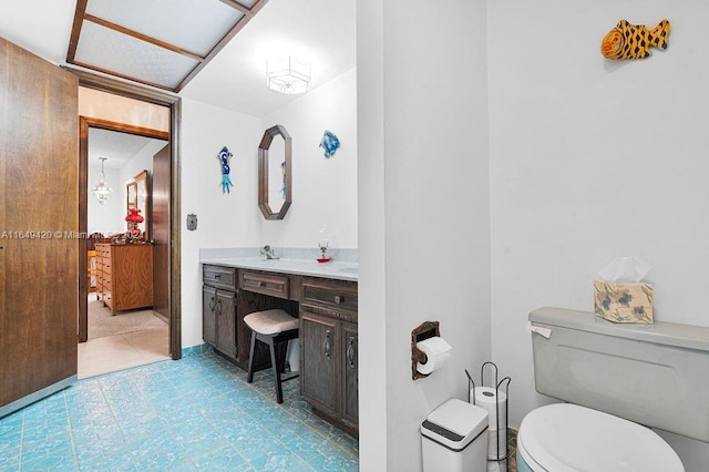 bathroom with vanity, toilet, and tile patterned flooring