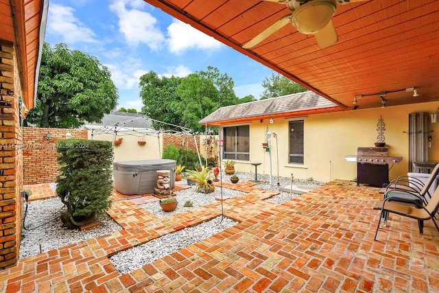 view of patio featuring grilling area, a hot tub, and ceiling fan