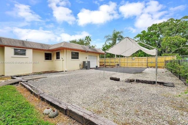 back of house featuring cooling unit and a patio