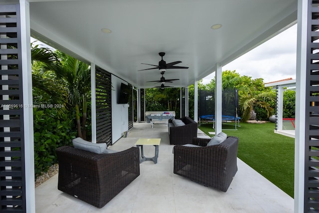 view of patio / terrace with ceiling fan, an outdoor hangout area, and a trampoline