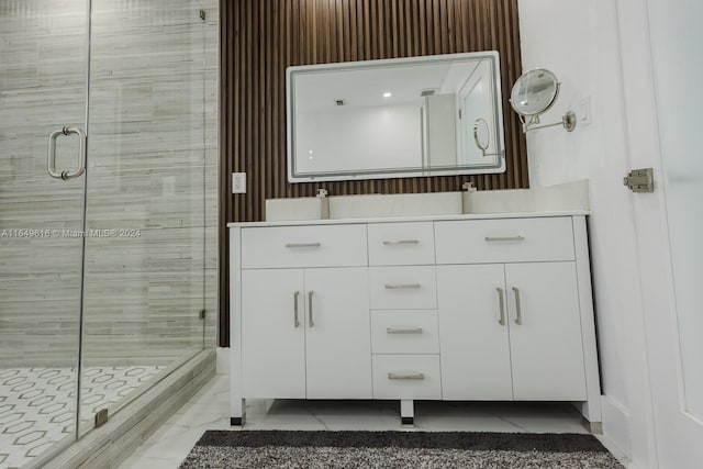 bathroom with vanity and a shower with door