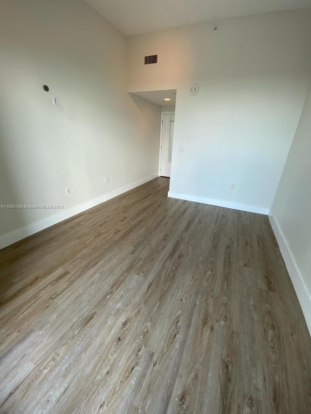 unfurnished room with hardwood / wood-style floors