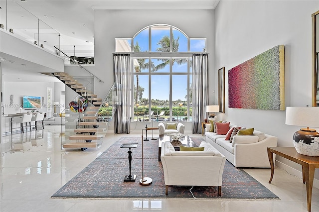 living room with a healthy amount of sunlight and a high ceiling