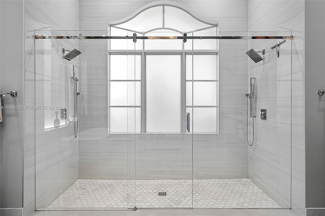 bathroom with a shower with door