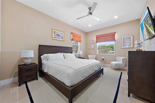 bedroom featuring light wood-type flooring and ceiling fan