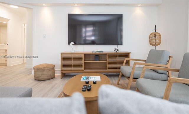 living room with wood finished floors, baseboards, and recessed lighting