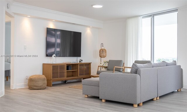 living room with crown molding, a wealth of natural light, and wood finished floors