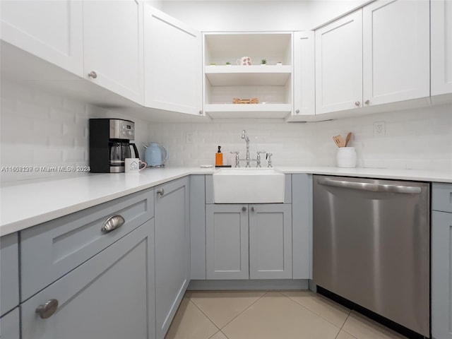 kitchen featuring light tile patterned floors, backsplash, dishwasher, and sink