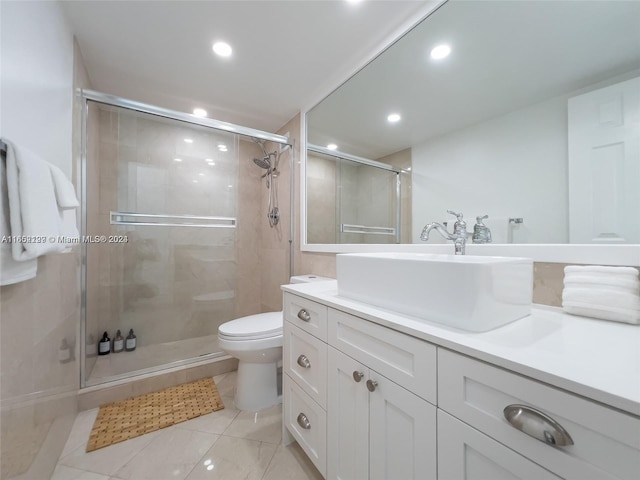 bathroom with vanity, toilet, tile patterned floors, and walk in shower