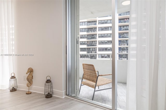interior space with baseboards and wood finished floors
