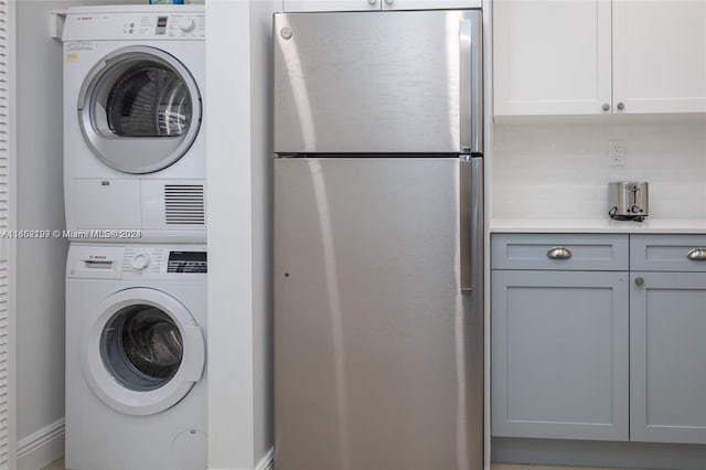 laundry area featuring stacked washer and clothes dryer