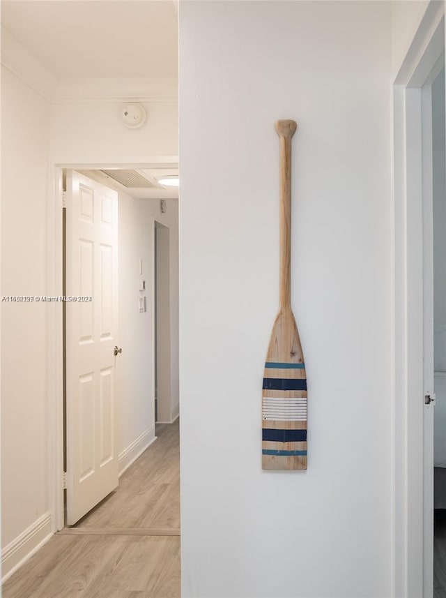 corridor with baseboards and light wood-type flooring