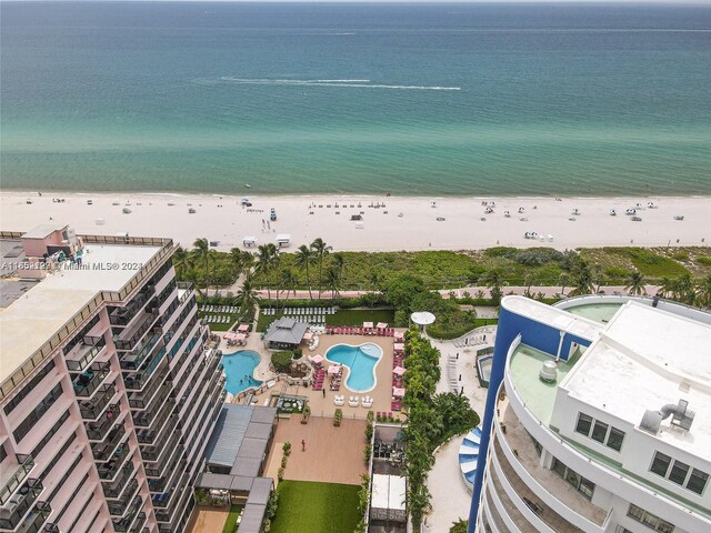 aerial view with a water view and a view of the beach