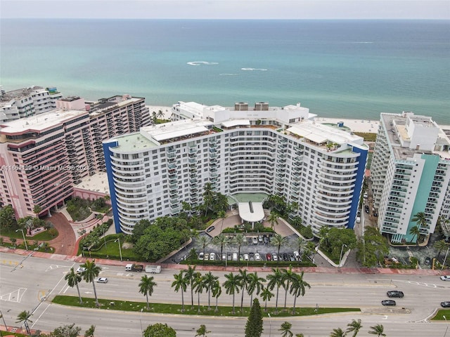 drone / aerial view featuring a water view and a view of city