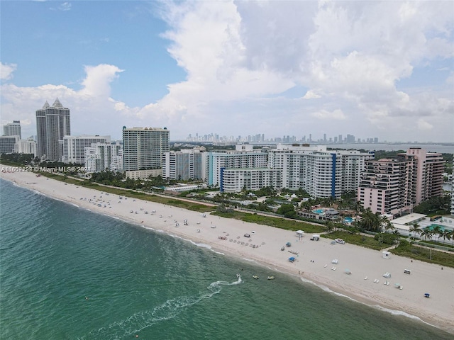 birds eye view of property with a beach view and a water view