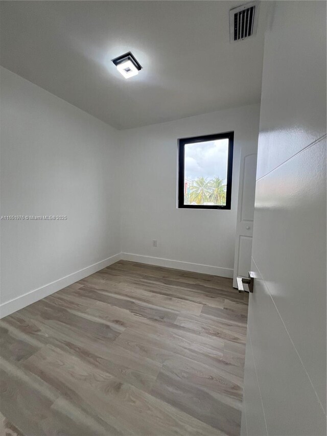 unfurnished room with light wood-type flooring