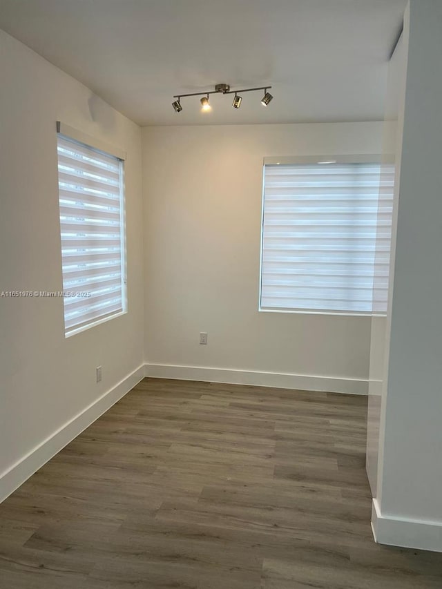 unfurnished room with dark hardwood / wood-style floors