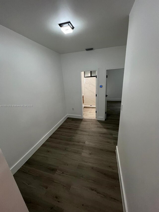 hallway featuring dark hardwood / wood-style floors