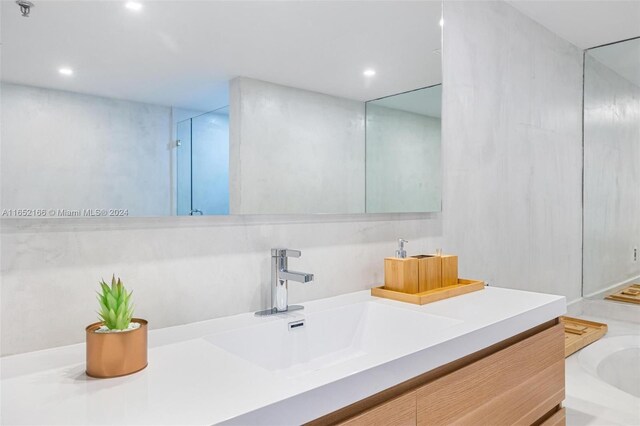 bathroom featuring vanity and a shower