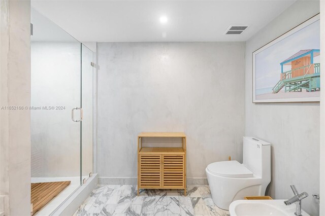 bathroom with a bidet, toilet, and walk in shower