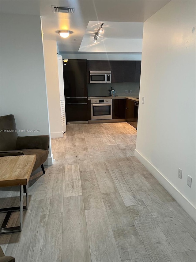 kitchen with light hardwood / wood-style flooring and stainless steel appliances