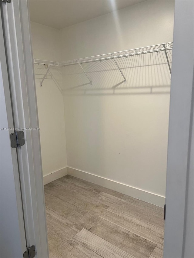 walk in closet featuring light hardwood / wood-style floors