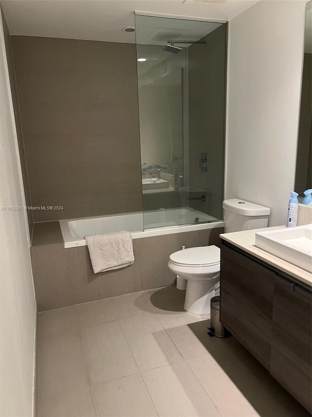 full bathroom featuring vanity, toilet, tile patterned floors, and tiled shower / bath