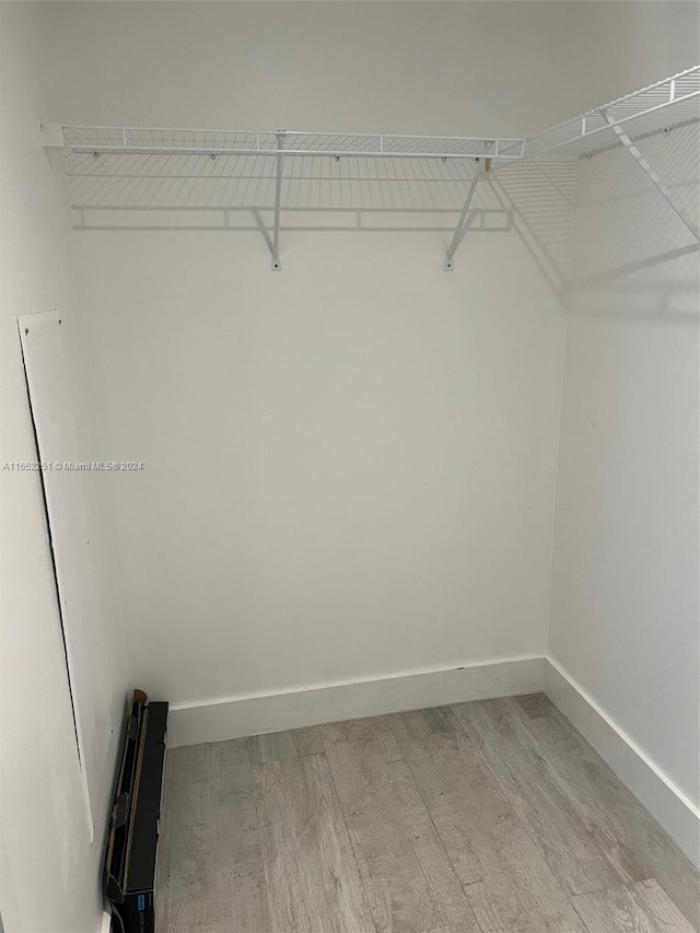 walk in closet featuring light hardwood / wood-style flooring