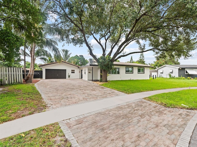 2320 SW 36th Ave, Fort Lauderdale, FL 33312 - ranch-style home with stucco siding, decorative driveway, a front yard, and fence