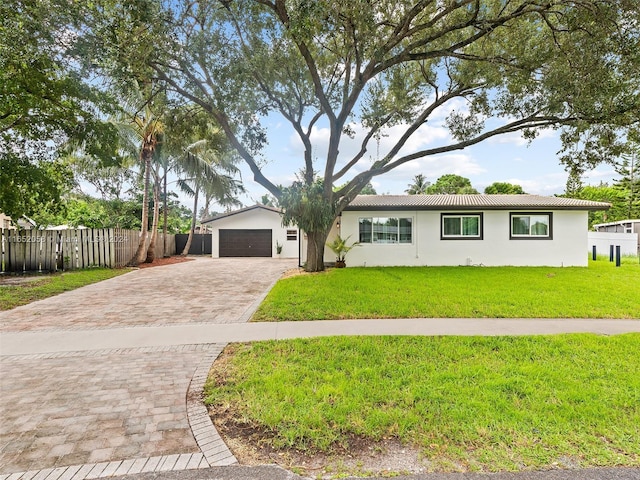 2320 SW 36th Ave, Fort Lauderdale, FL 33312 - ranch-style house featuring fence, a front yard, stucco siding, decorative driveway, and a garage