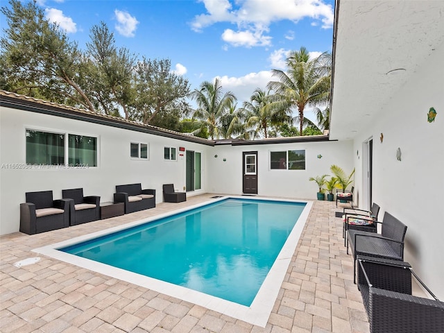 view of pool with a patio and an outdoor hangout area