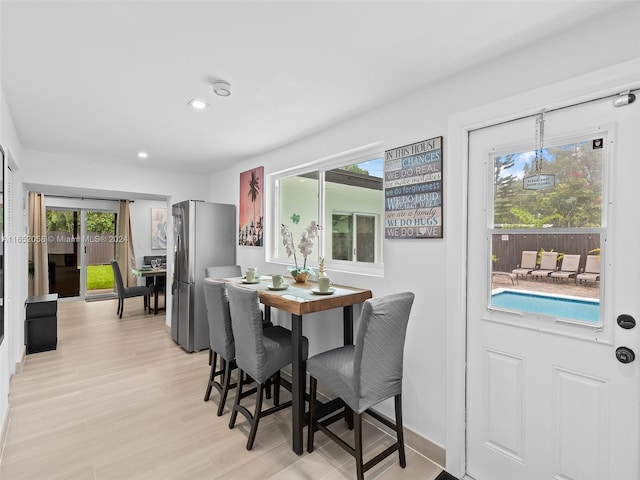 dining space with light hardwood / wood-style flooring