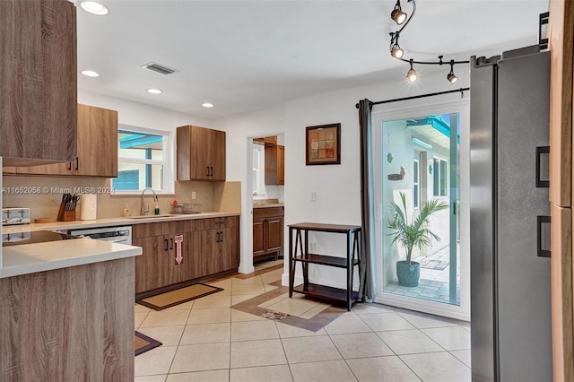 2320 SW 36th Ave, Fort Lauderdale, FL 33312 - kitchen with light tile patterned floors, visible vents, freestanding refrigerator, light countertops, and backsplash